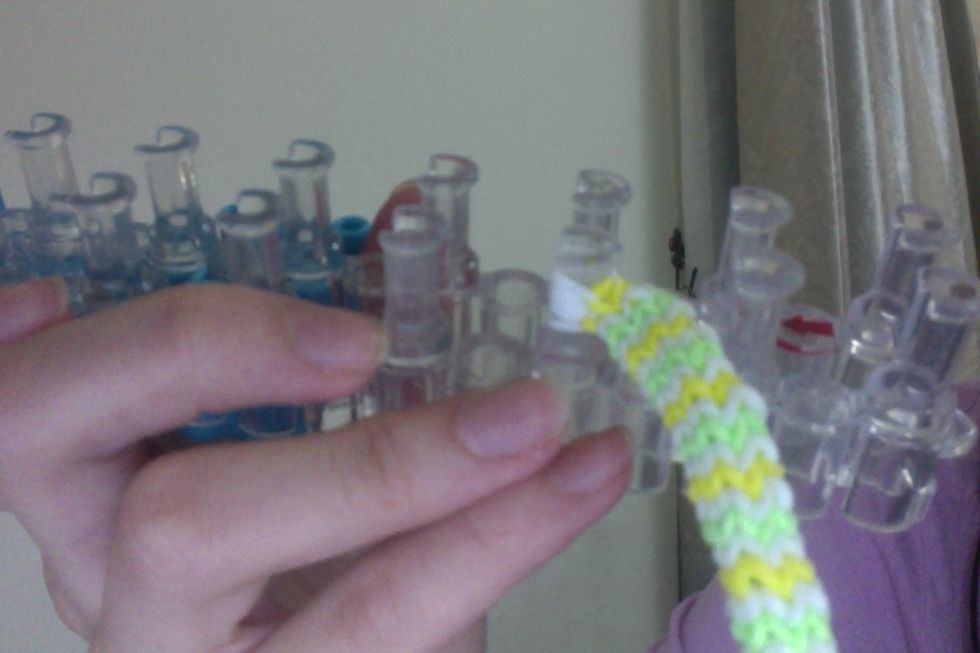 and loop it onto the left peg. So it should look like this.