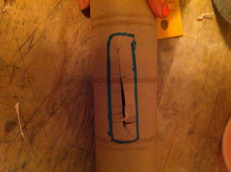 And make little slits from the big slit in the middle to the drawn rectangle