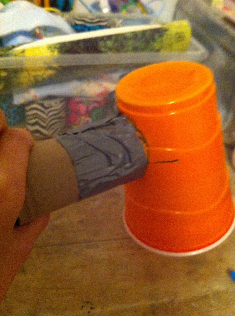 And making sure the two lines you just marked are lined up, tape the flaps of the cups to the towel roll