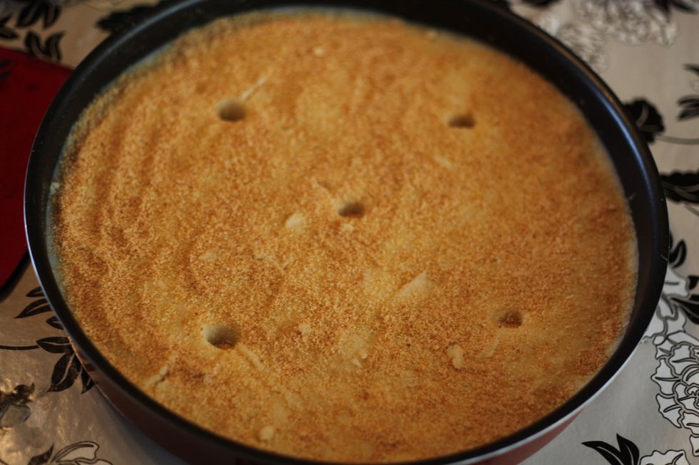 And now go all out with the balance of your breadcrumbs. Sprinkle it around all over as much as you like. Add the ghee or butter near those holes. It should be about 5 small teaspoons.