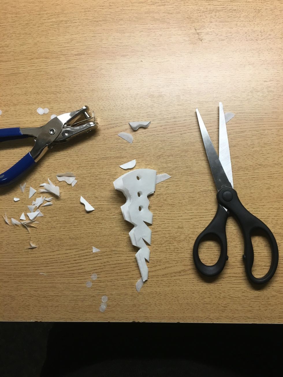 And now go crazy! I used both scissors and a hole punch to add various designs. If you want to hang yours up by a string it's a good idea to punch a hole near the curved edge.