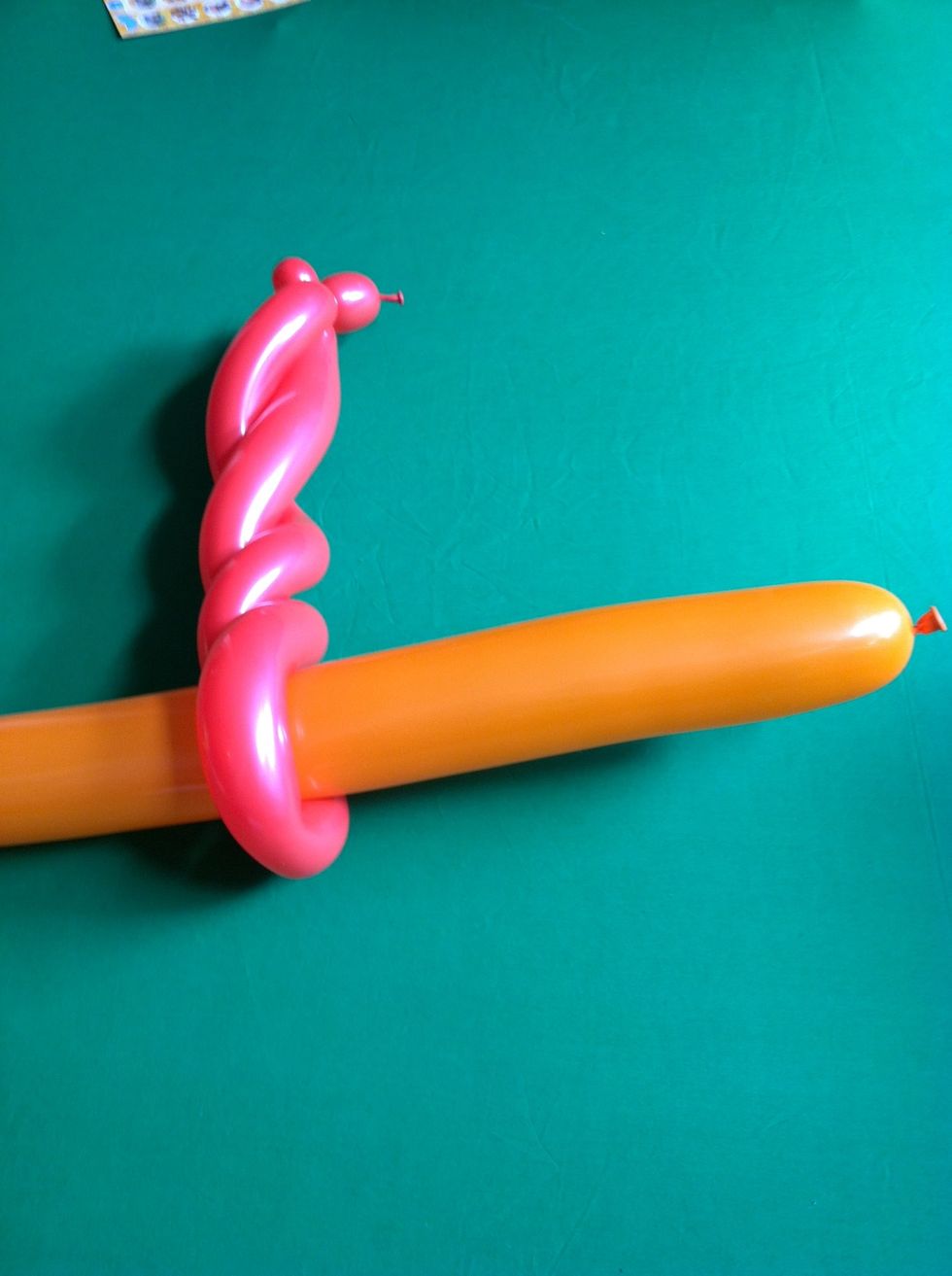 And put it through the spiral at the bottom of the twisted balloon