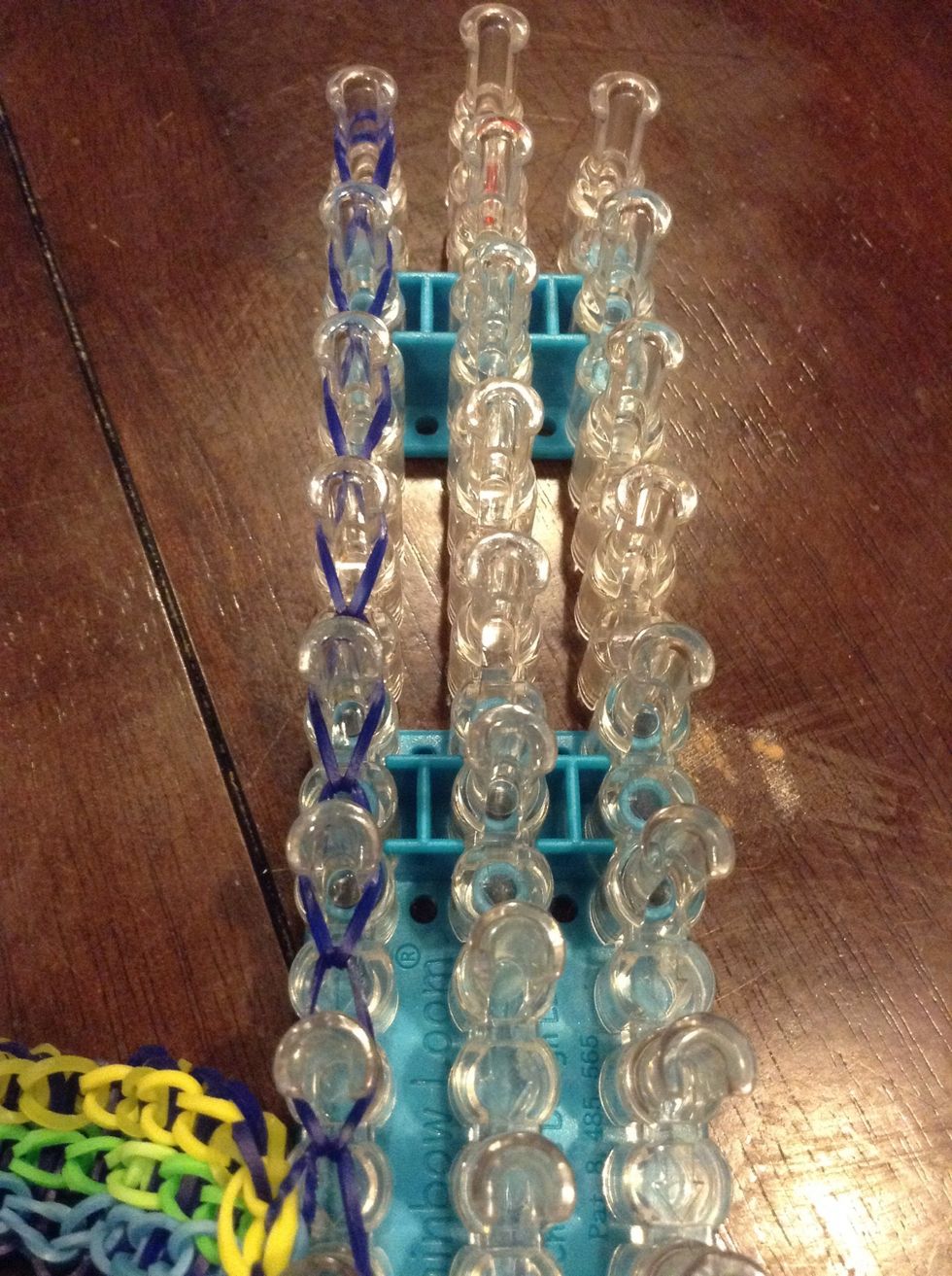 And start hooking the first rubber band to the front rubber band keep going until the end