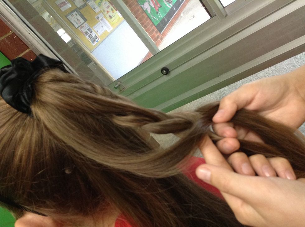 And start plaiting down three again and join another little bit of the pony tail to your plait. You do this all the way down the pony tail