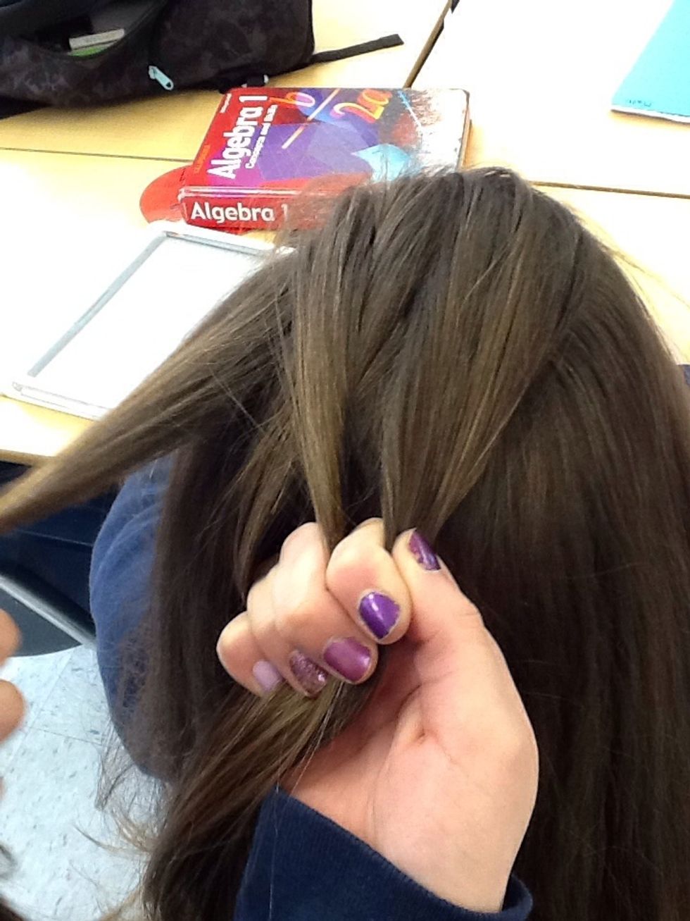 And take a piece of hair from the head (not part of the first three sections) and cross it to the middle while still holding the first three strands