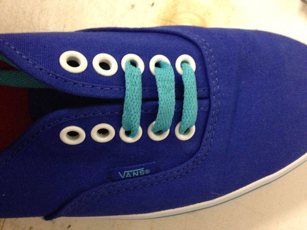 And take the lace on the right and cross over put it in the loop on the left