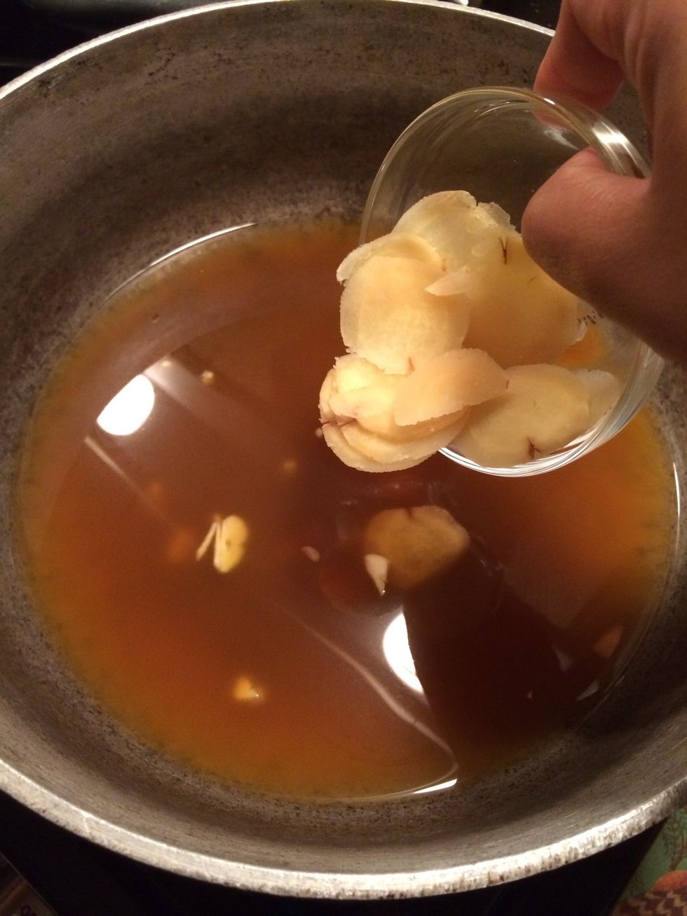 And the sliced ginger root. Before adding the rest of the ingredients we will let the ginger and garlic simmer in the broth for about 10 minutes. This will give our broth a nice flavor.