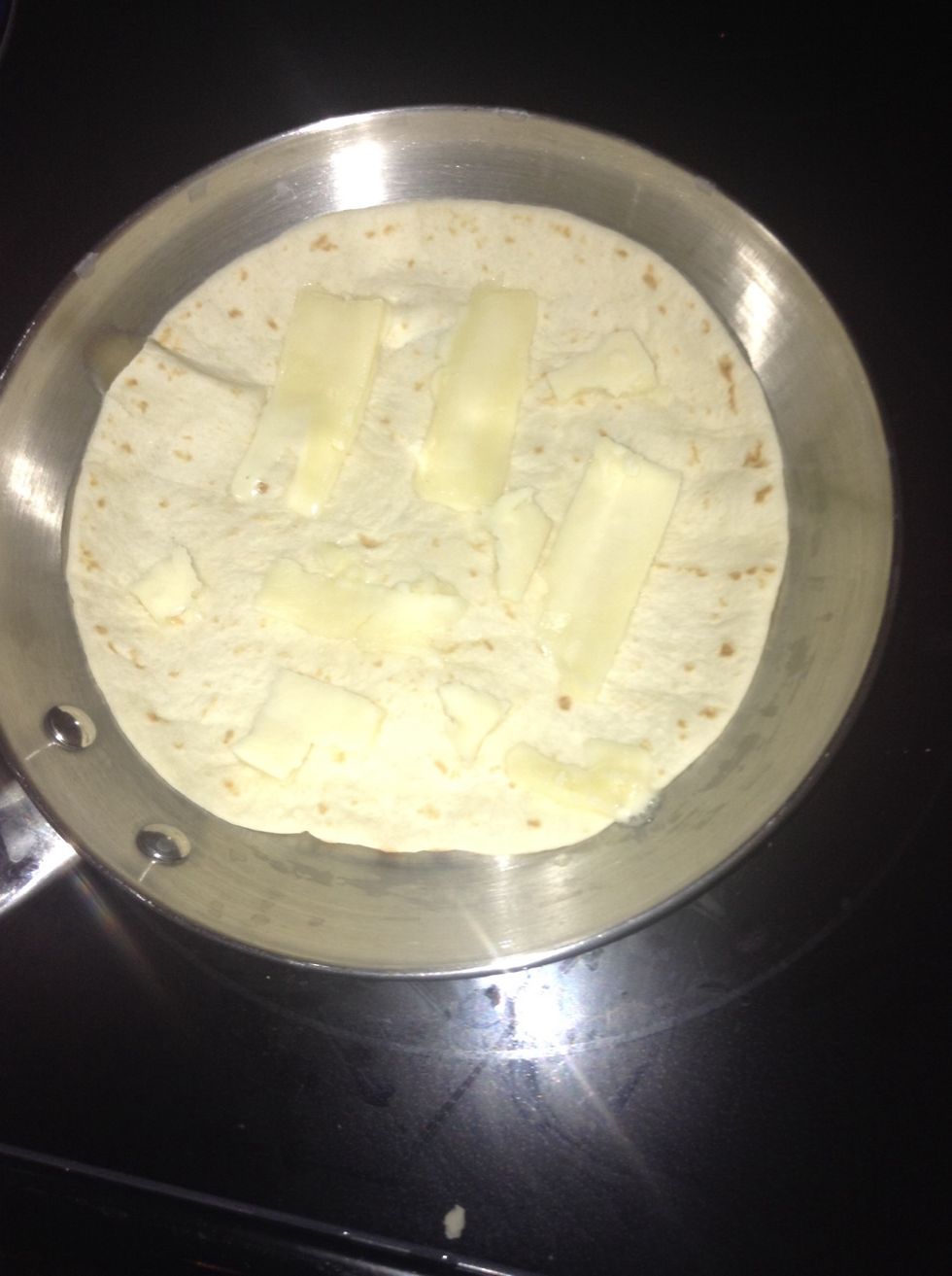 And then cut some thin pieces of cheese and put it all over the tortilla and add some other toppings if you want remember to let the cheese melt!