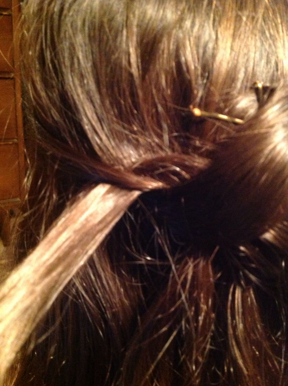 and then tuck it in on the left of the hair tie.