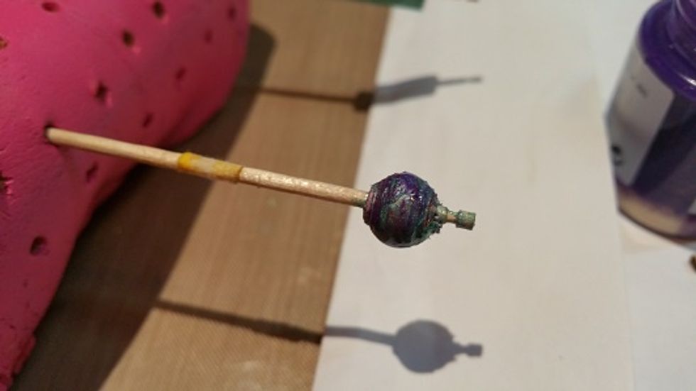 And this is after I've used some left over paint from the flowers to coat the bead. I then spin the bead every couple of minutes until the paint no longer runs so that beads and pooling doesn't occur.