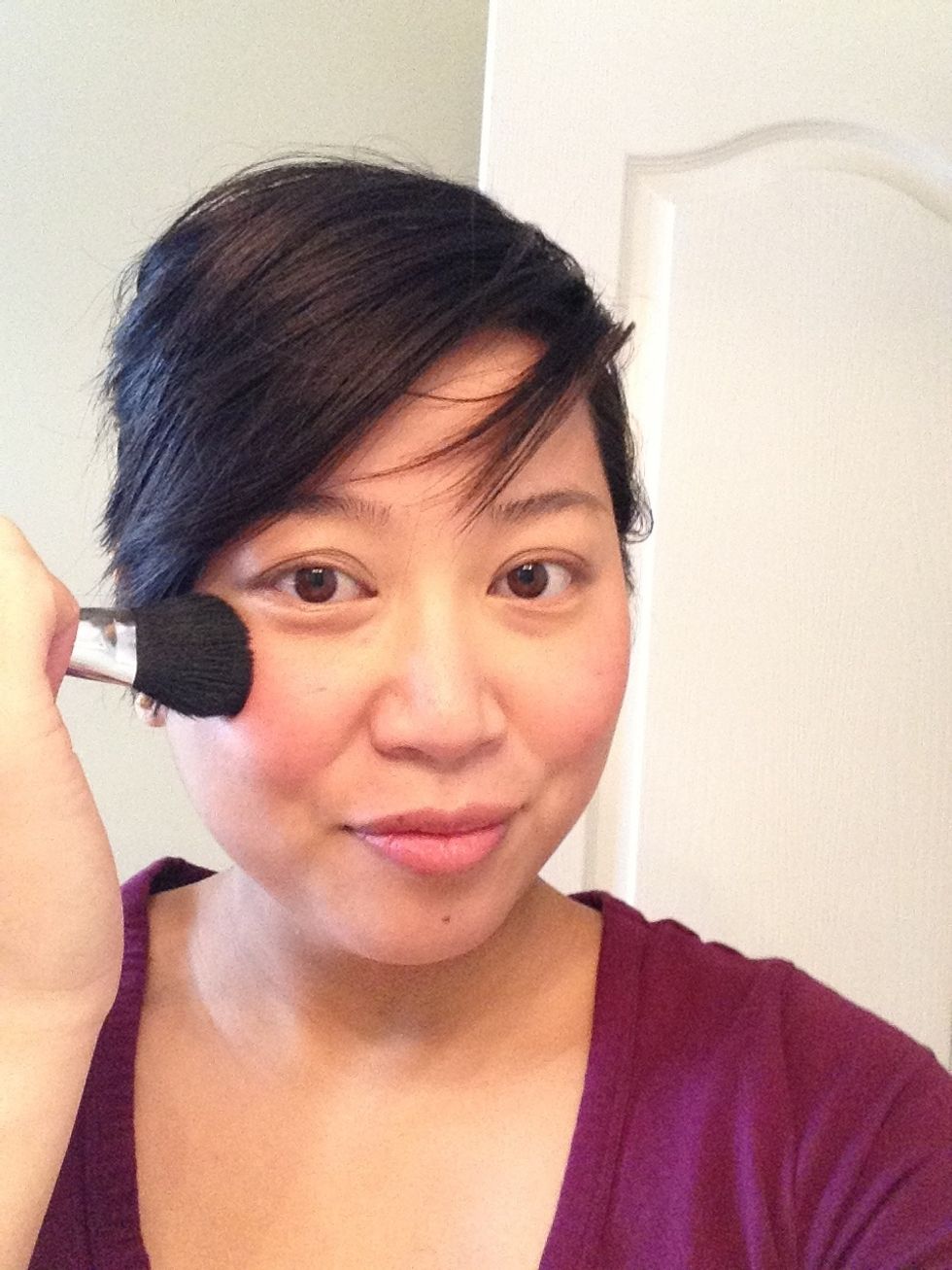 And to blend my blush into the skin for a soft glowing and halo-y effect, I will buff the entire face with a clean blush. Just work it over the entire face in a circular buffing motion.