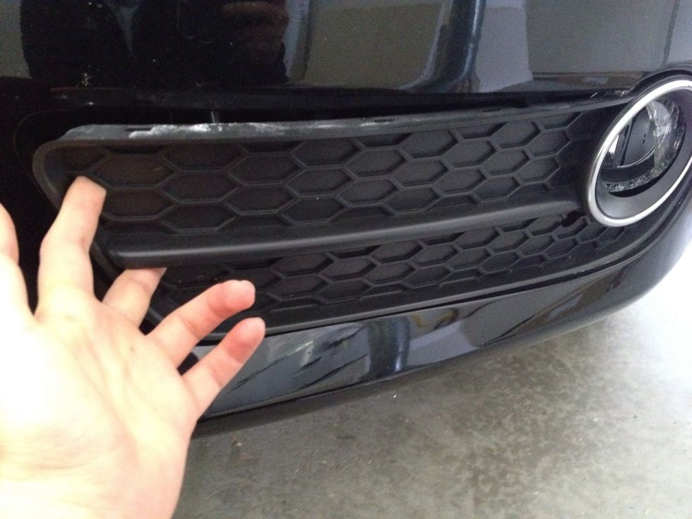 And we begin: stick your fingers into the two holes of the fog light panel. Lightly pull until inner (left) side becomes loose. CAUTION: DO NOT FORCE PANEL OFF, YOU CAN BREAK CLIPS IF TOO ROUGH!