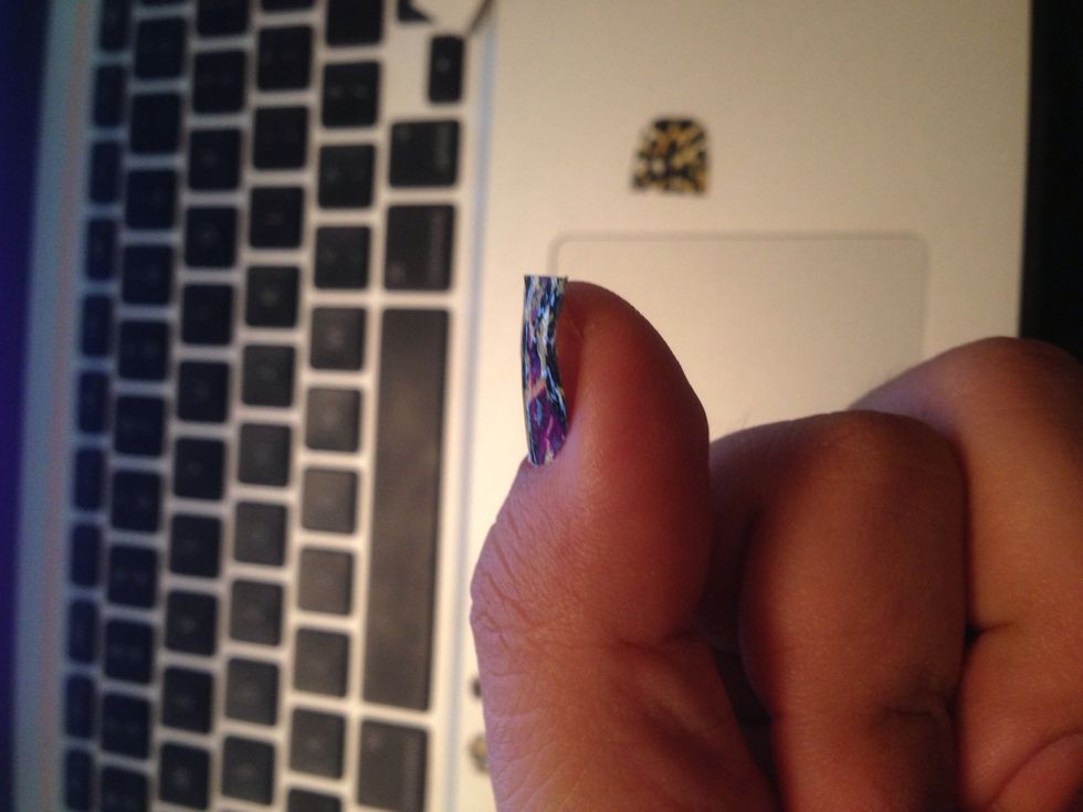 And with your index finger guide the strip down to the end of your nail bed and then do the same with the sides.