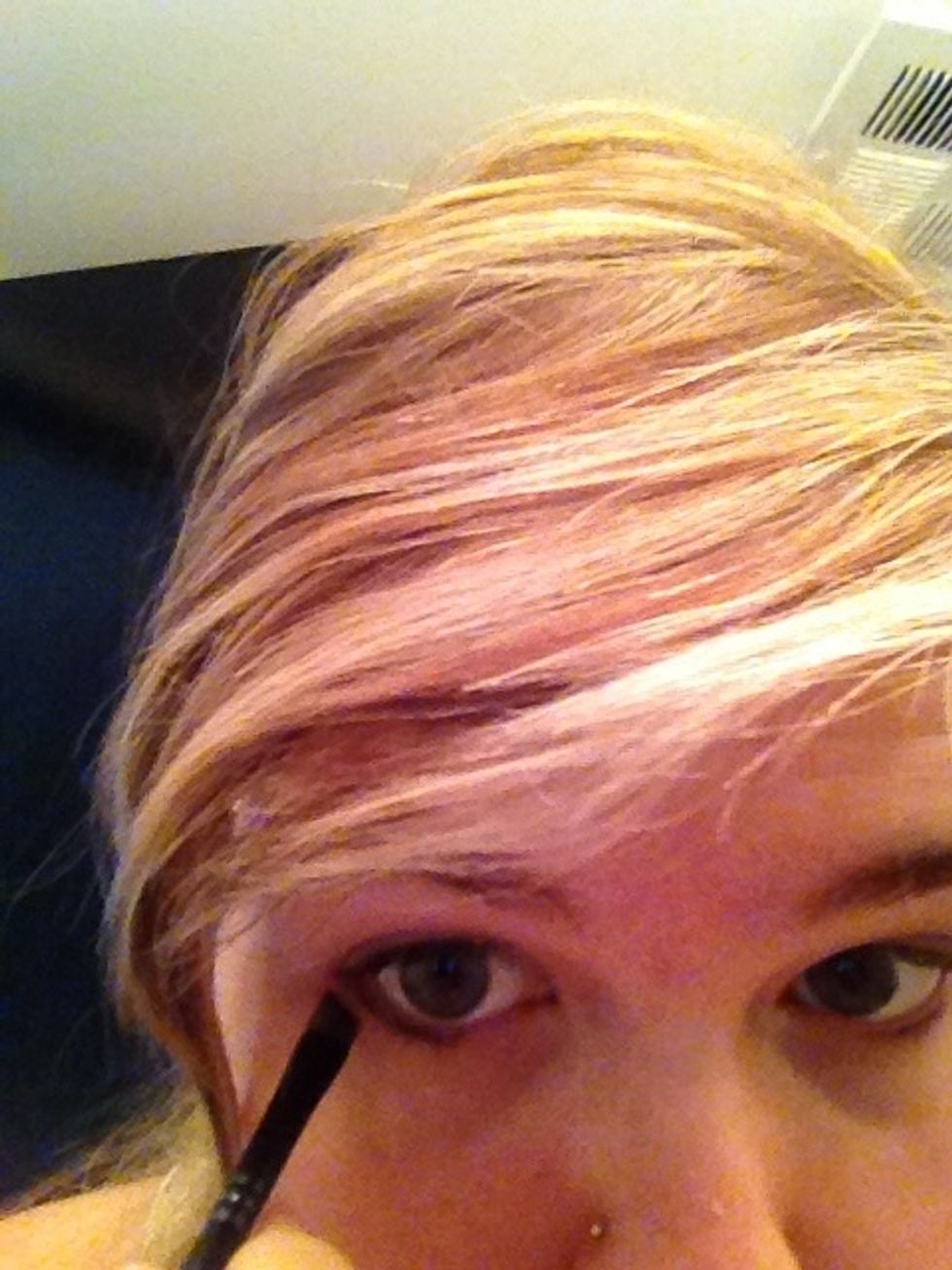 Angle your brush and sweep downward a few times UNDERNEATH the waterline about halfway. (Or a bit less for more natural)