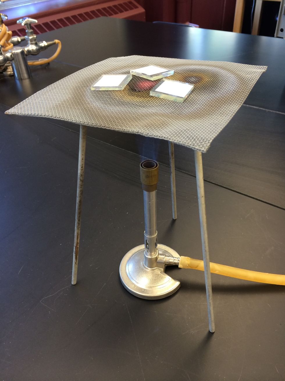 Anneal the TiO2 on the conductive glass using a gas burner. Place the film on a ring stand at the tip of the flame for 10-15 minutes.