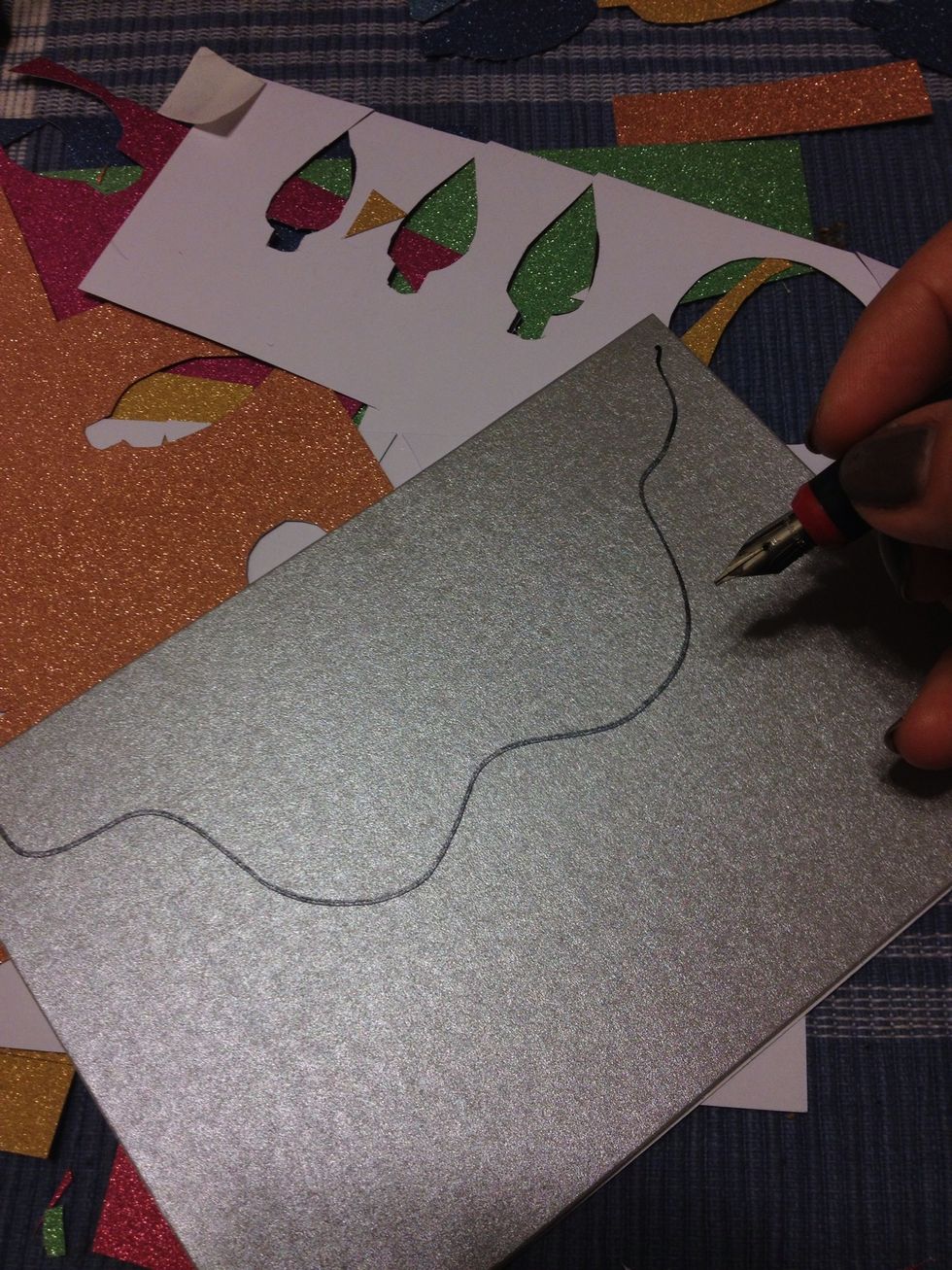 Another design I love is the Christmas light strand. Start by drawing a wavy line with a black pen or marker...