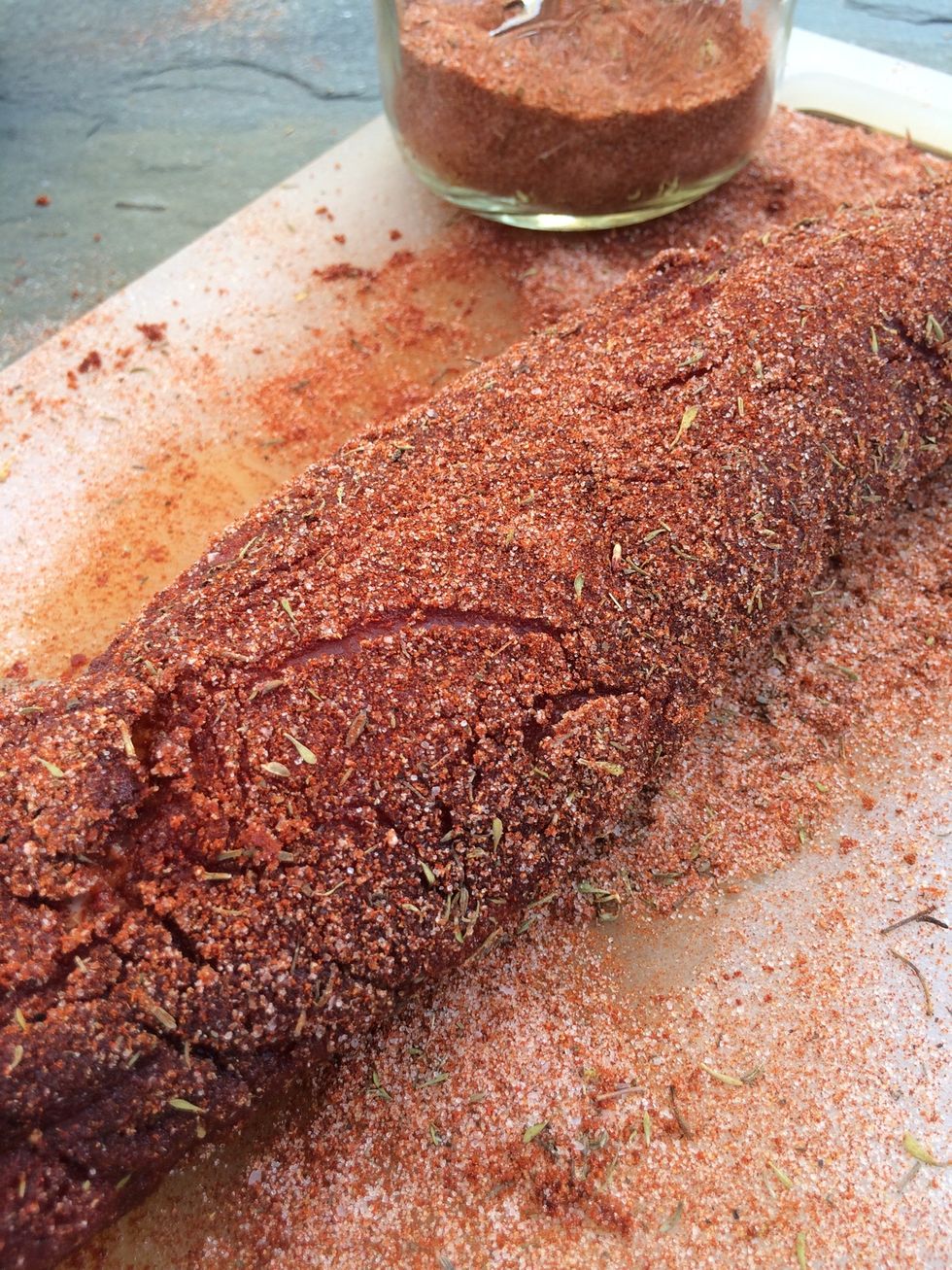 Another light dusting of BBQ rub before it hits the grill.