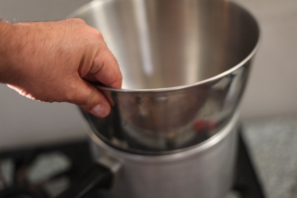 Another method: Try holding the tempering bowl for a few seconds. If you burn your hands, then call emergency. HOWEVER, this is not possible as there's no flame or fire yet under the pot of water.