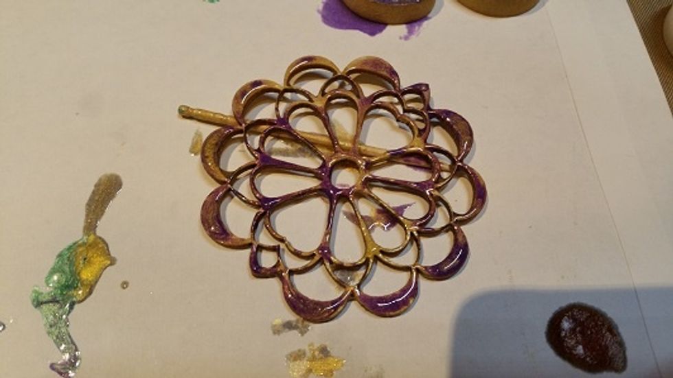 Another wooden embellishment. Here I've used pearl violine and antique gold mixed together to achieve this effect. I then used a toothpick to gently lift the flower off the paper.