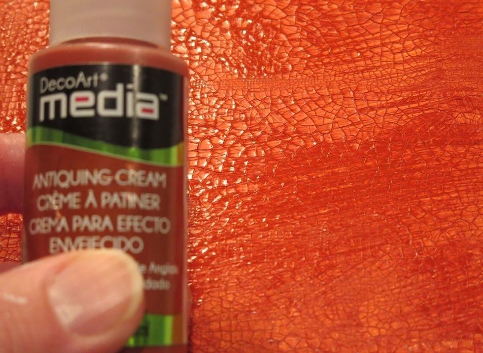 Antiquing cream was brushed on the entire canvas.  It's a fluid that dries quickly.  It is not permanent so you can wipe off the excess you don't want with a damp cloth.  I used baby wipes.