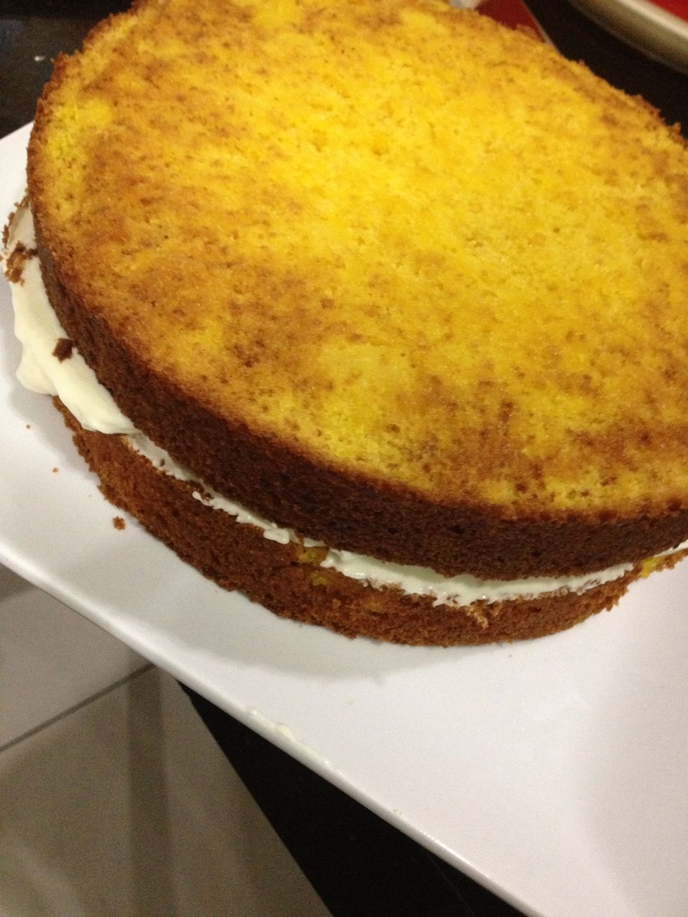Anywho, place some frosting on the bottom layer and even it. Then place the other cake on top and start frosting the whole cake. Once frosted, place in the fridge for about 2 hours to set.