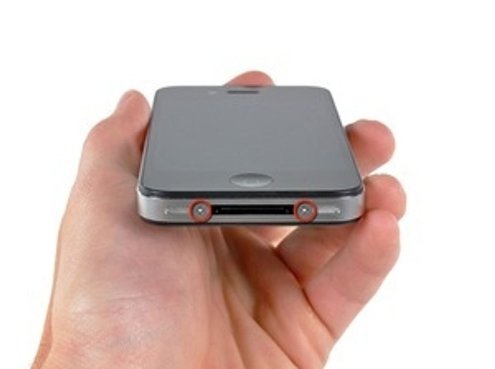 Apple has recently substituted the two Phillips screws with 5-Point "Pentalobe" screws.  Remove the two 3.6 mm Pentalobe screws next to the dock connector.