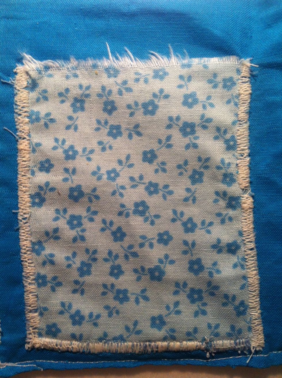 Appliqu\u00e9 the pocket onto the plain fabric (to the left of the middle half-line crease!) Make sure there is still room either side of the pocket. NOTE: Only sew the bottom and sides - not the top!!