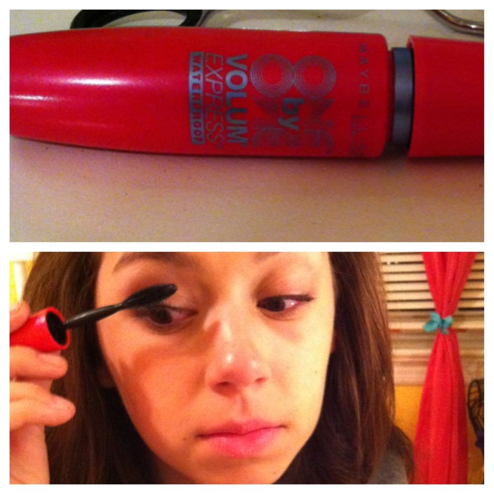 Apply 1-2 coats of black or brown mascara to your top lashes by holding the wand at the base of your lashes and wiggling it side to side as you move up your lashes.