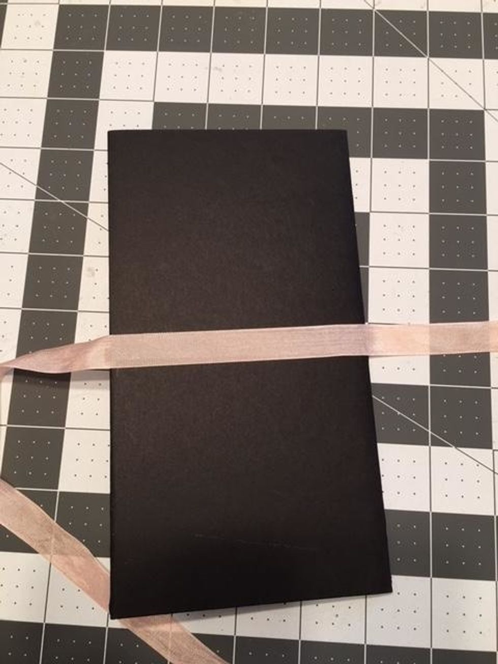 Apply 1/4" or 3/8" Scor-Tape to the center back using your pencil mark as a guide.  Peel off the tape backing and center a 36 inch piece of seam binding ribbon onto the tape. Leaving the ends loose.