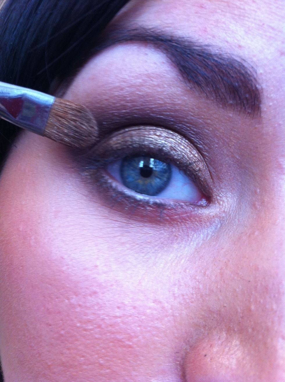 Apply a beautiful shimmery gold to the centre of the eyelid and to your inner corner of your eye.