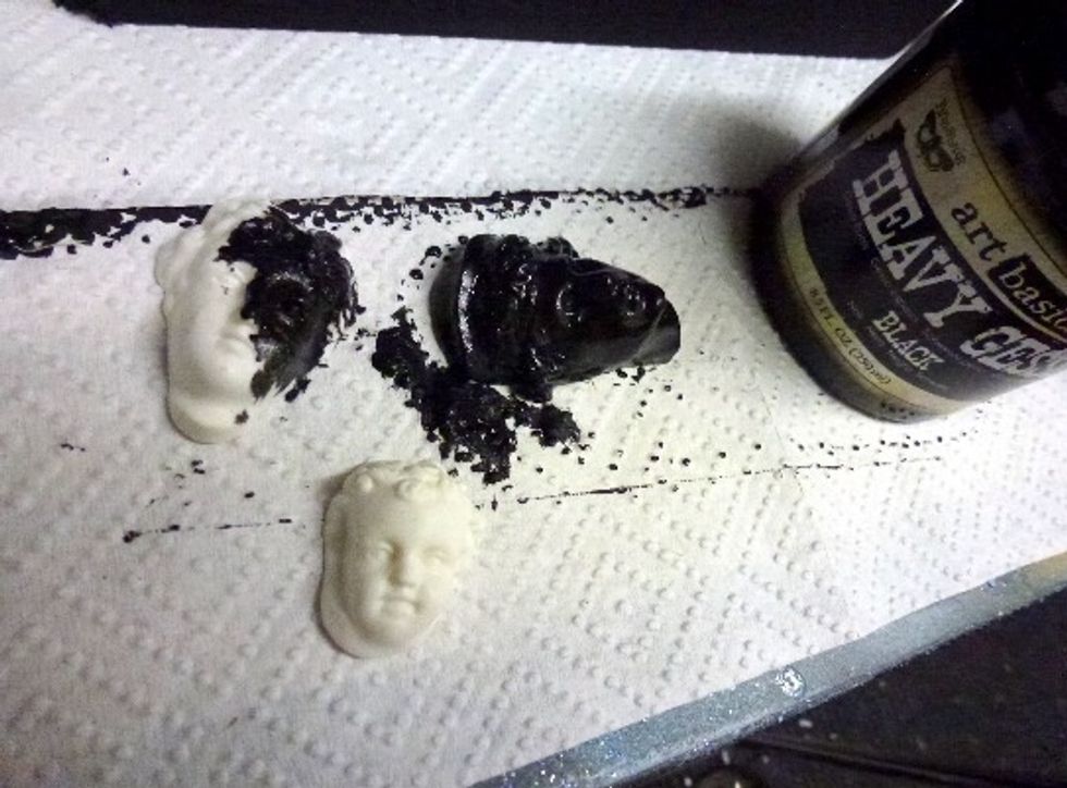 Apply a coat of heavy black gesso to both the chest of drawers and cast figureheads.