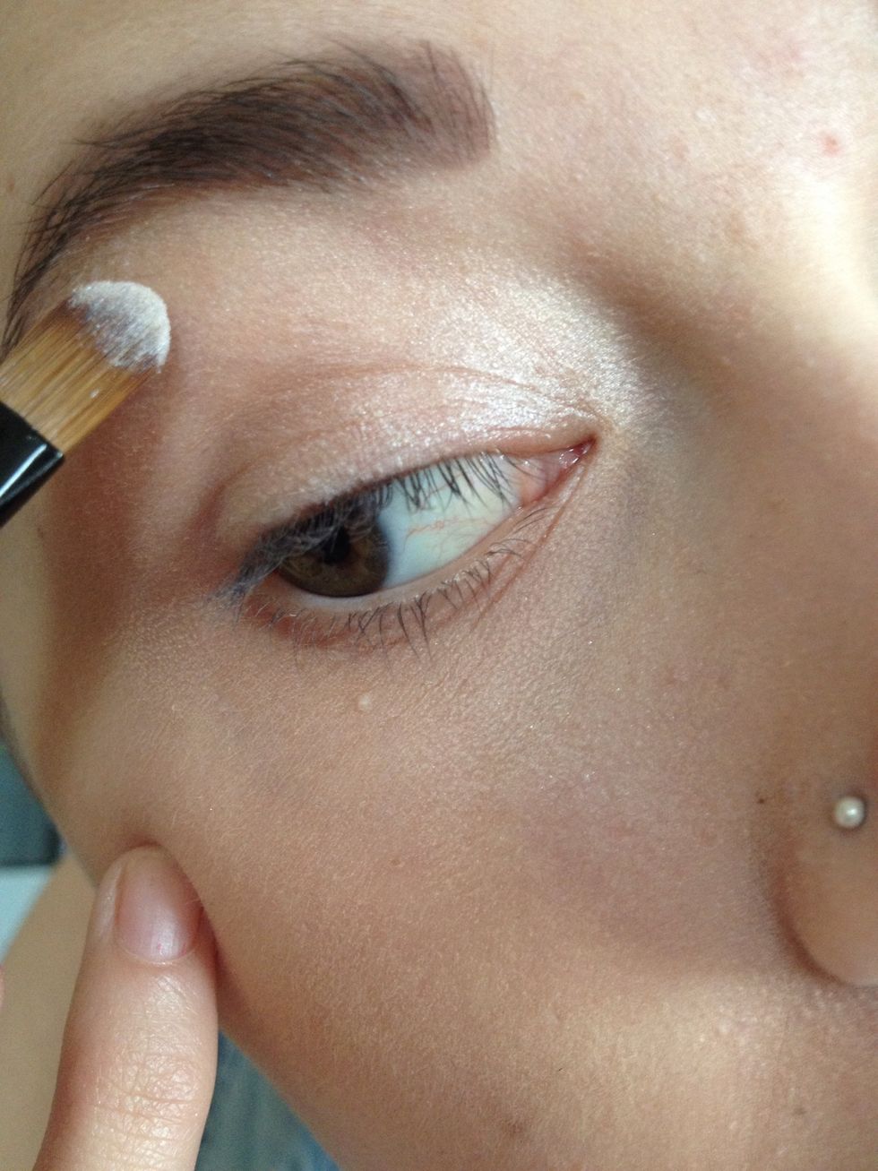 Apply a creamy white shadow under the brow to highlight