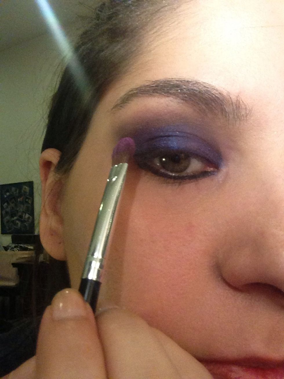 Apply a deep purple eye shadow blending in to the crease and edges, also add black gel eye liner on your lower lash line