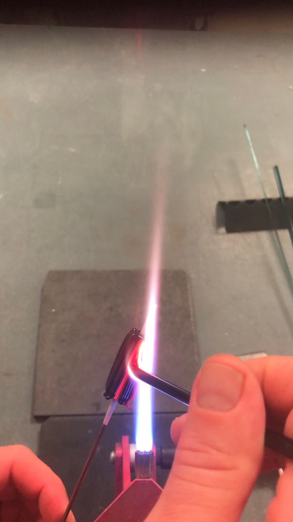 Apply a fourth stripe, then fill in the four spaces. Check for gaps, and fill them with hot glass.