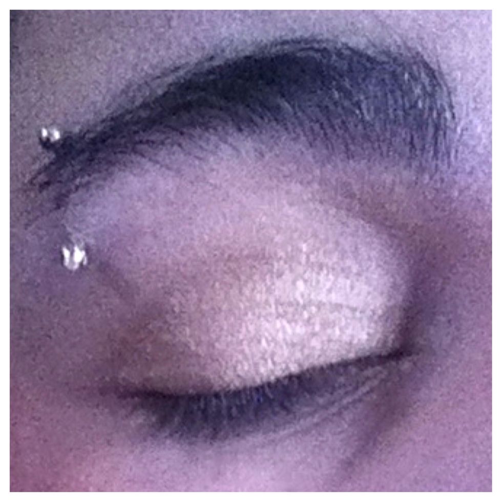 Apply a gold shade all over your lids.