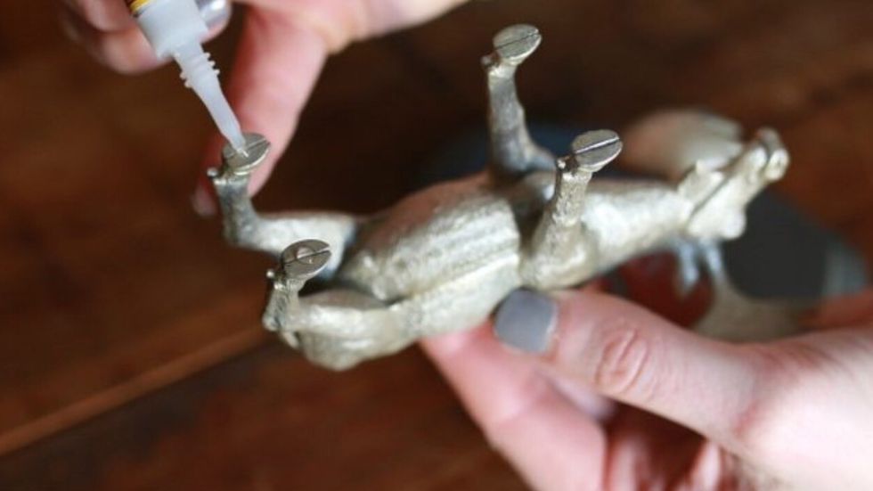 Apply a small dot of super glue to the feet of the moose, using less than you think, to avoid spillover.