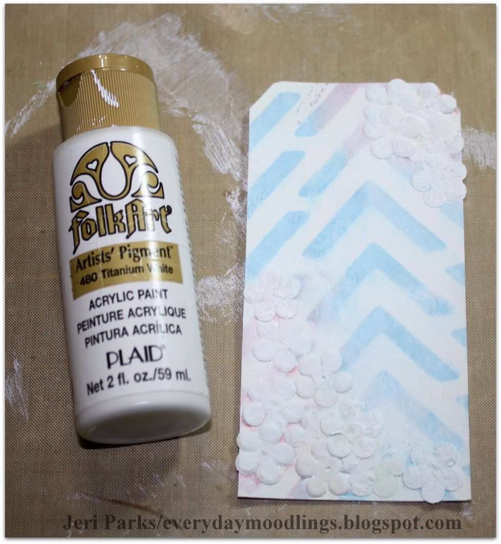 Apply a thin layer of white paint to the tag. This will help bring the background together and give it a cohesive feel. Add more paint if necessary.