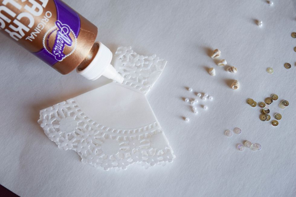 Apply a thin line of Tacky glue to areas on the dress where you want some extra sparkle and add your embellishments.