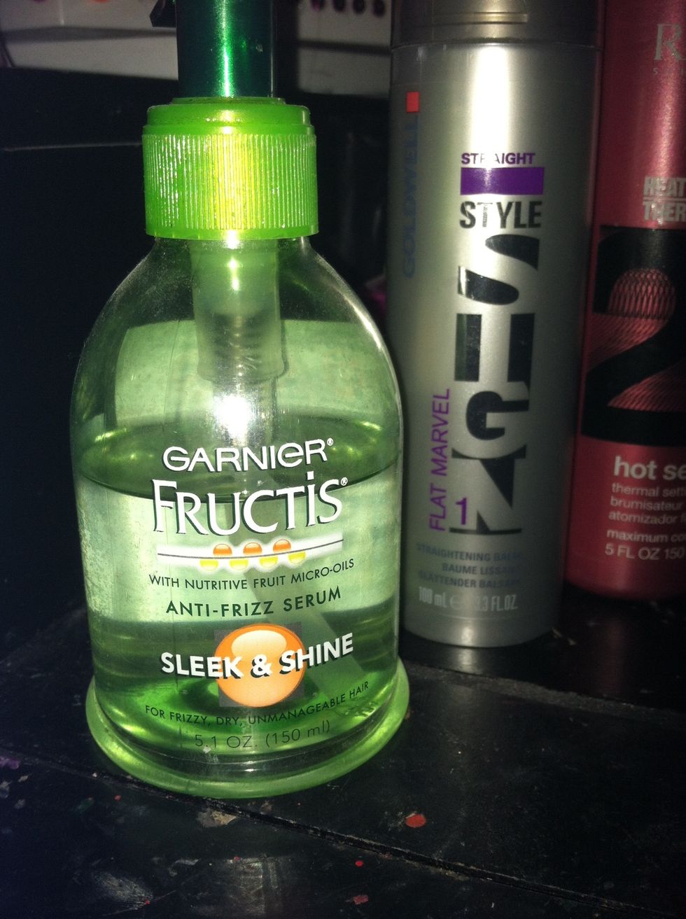 Apply a very small amount of anti-frizz serum, mousse, or spray (whichever you chose will work). Start application from ends and work your way up to your roots(don't use too much or it will be greasy)