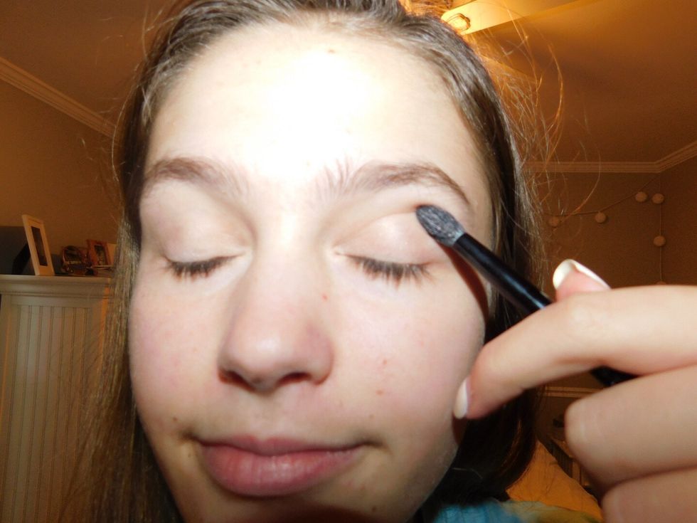 Apply an all white color, or a color close to your skin tone. Apply it all over the lid and up to the brow bone. This is the base