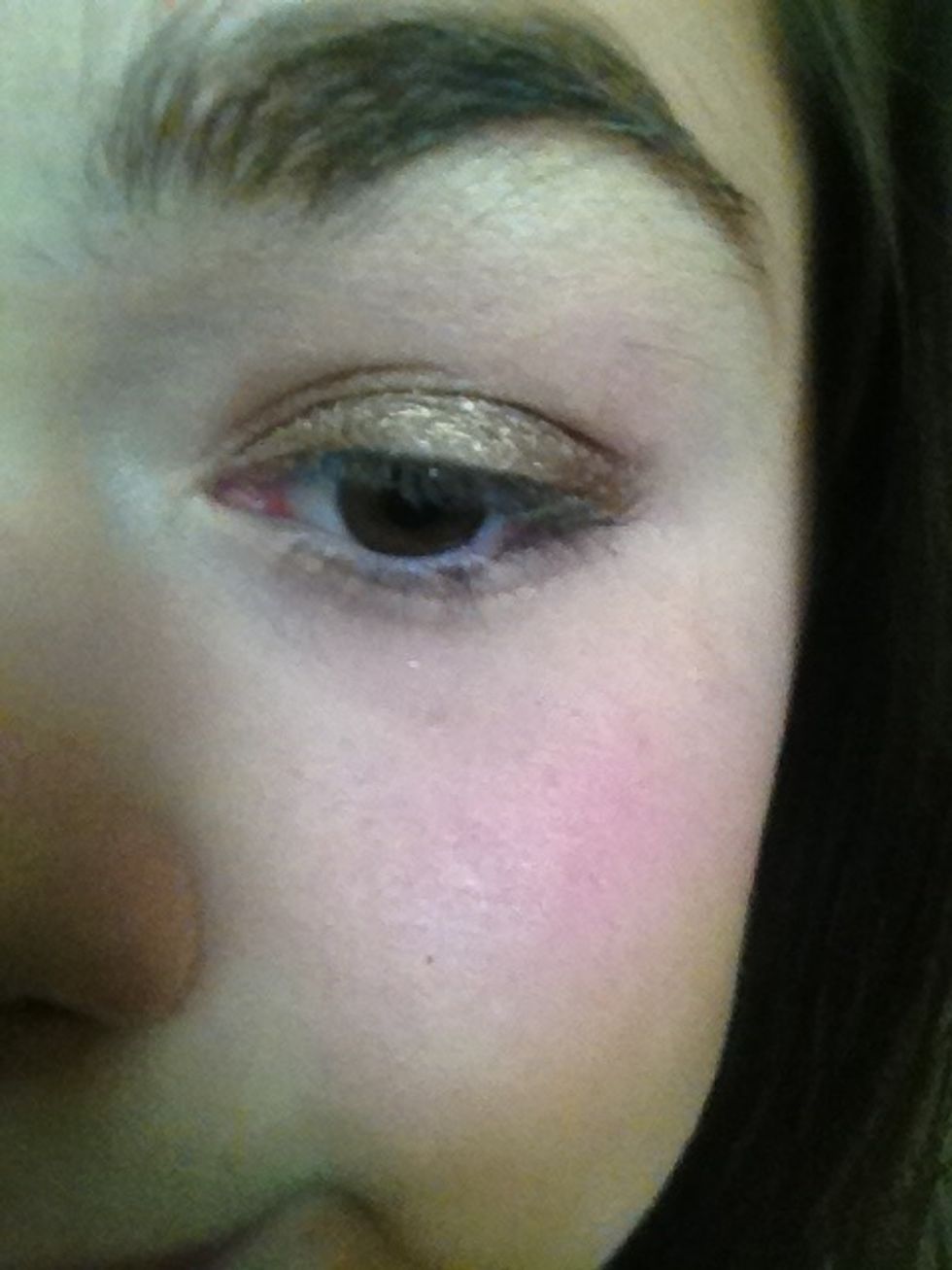 Apply any light brown or bronze to your eyelid on top of the cream shadow applied before.  Product used: Wreckage by Urban Decay.