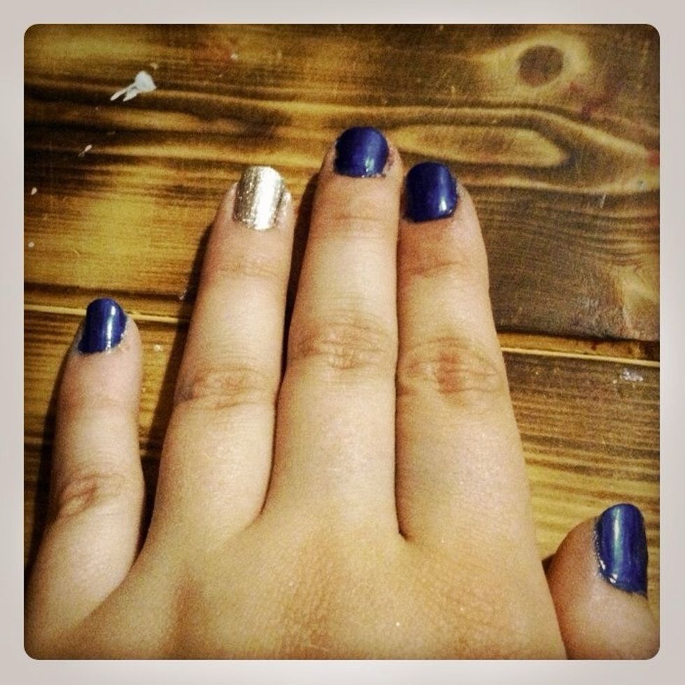 Apply base coat and then paint all nails except the ring fingers blue. Paint the ring finger silver.