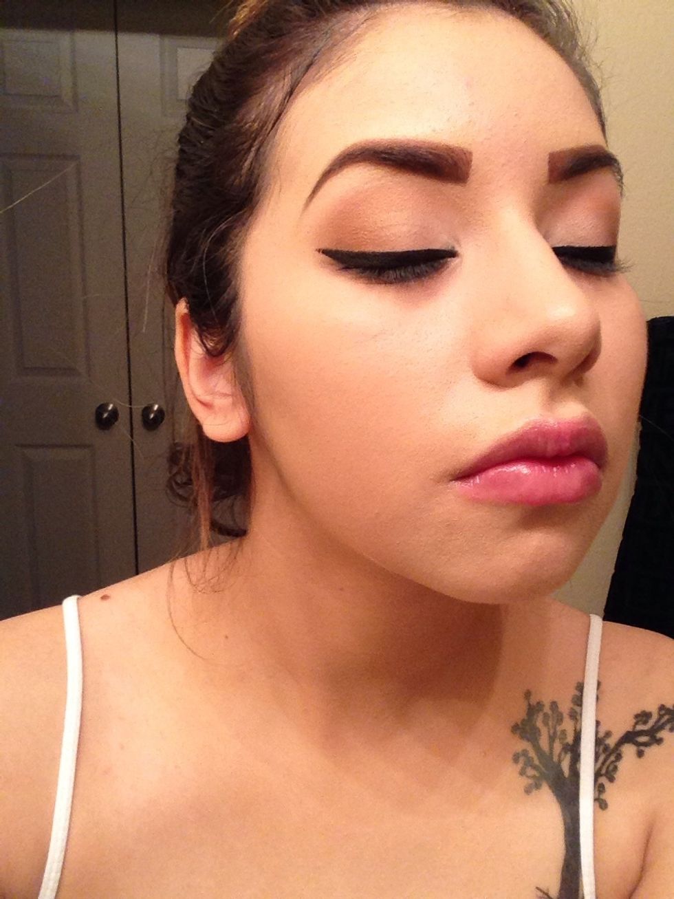 Apply black liner on top lids.