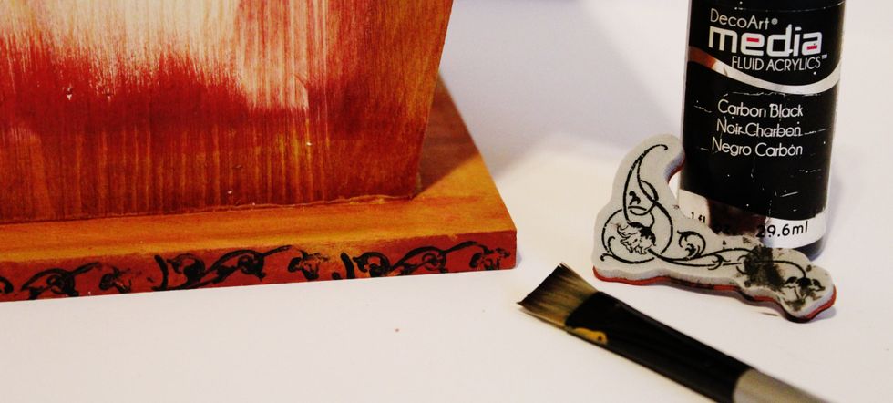Apply black paint to stamp with paint brush. Stamp edges of birdhouse. Dry