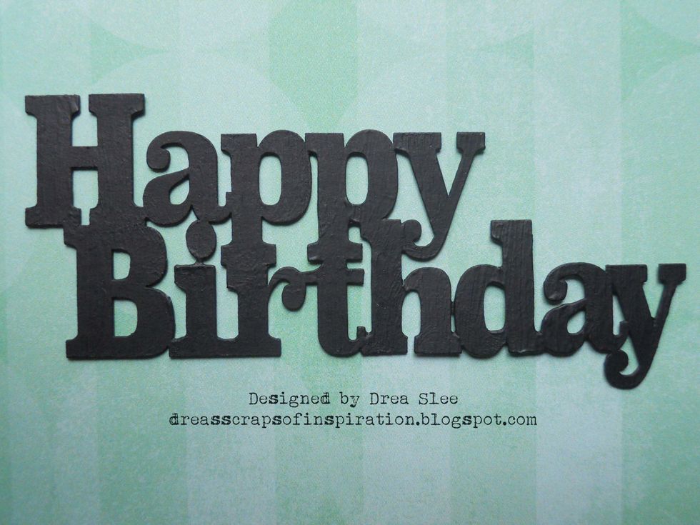 Apply black paint to the laser cut Happy Birthday chipboard piece.