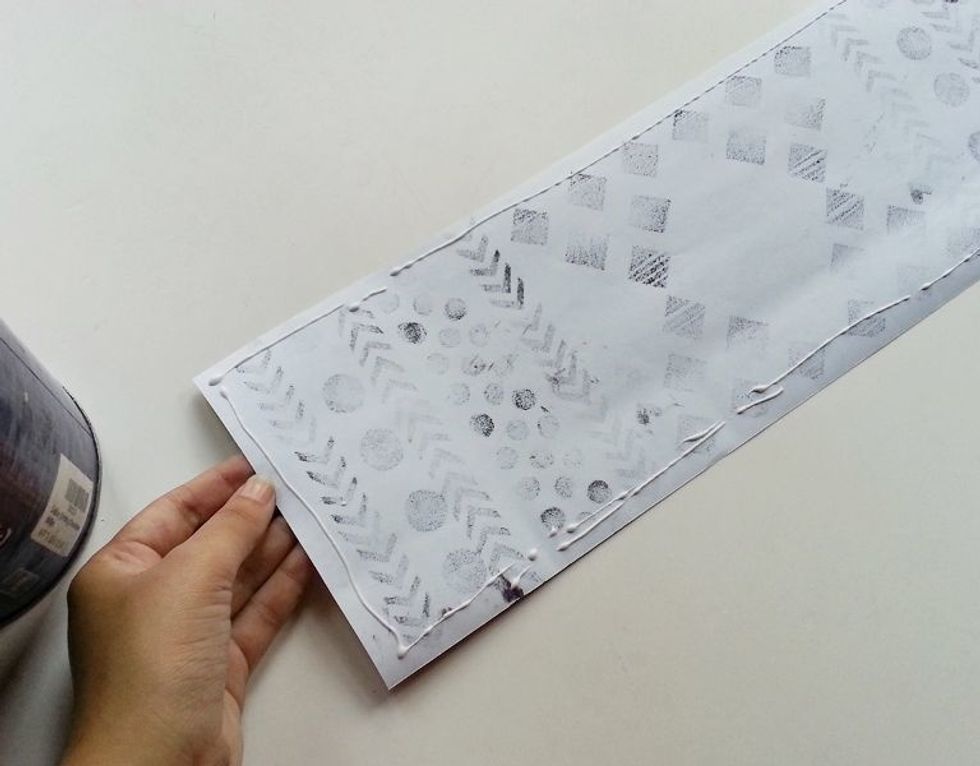 Apply craft glue at the back side of the printed paper. Apply glue along the border.
