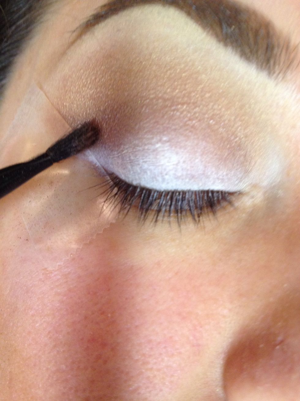 Apply darker shade to lower crease and outer V.