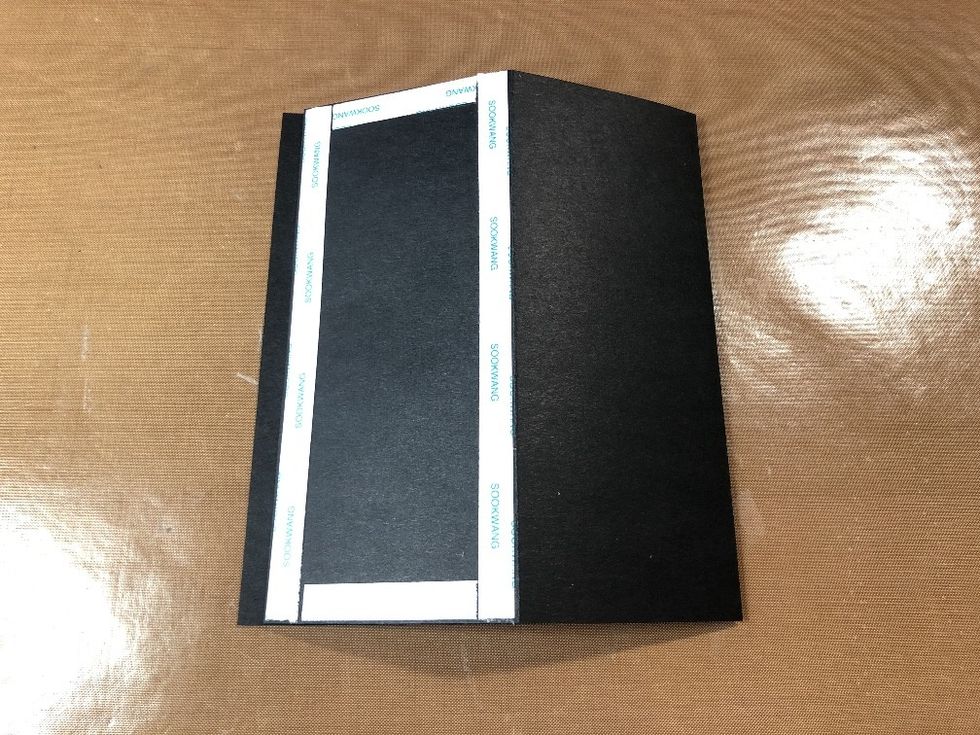 Apply double-sided tape along the edges of the first small panel, as shown.