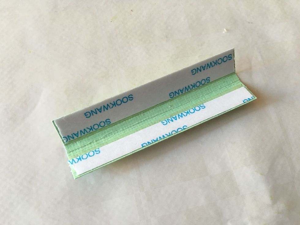 Apply double-sided tape to the insides of the flaps. Make sure NOT to cover the score lines.