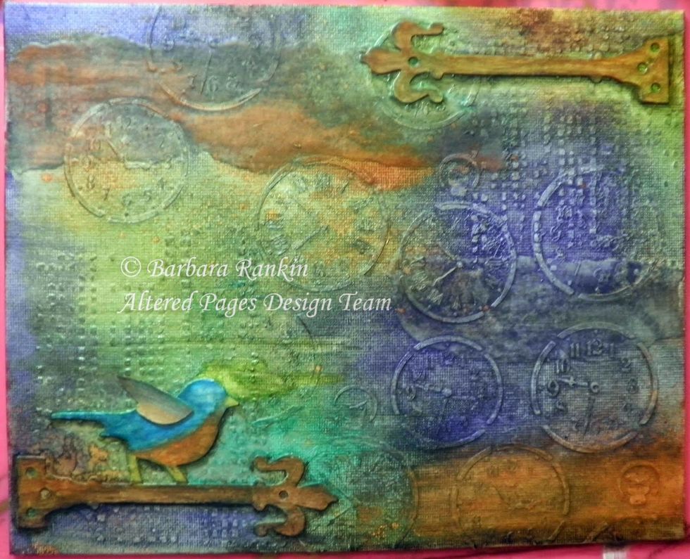 Apply Faber-Castell Gelatos in metallic blue, orange, and ochre, to the bird. Apply orange and rust to the hinges. Add shadows to the hinges and bird with black Gelato and a damp brush.